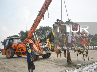 KMC workers clean the banks of the Ganges River on the last day of the Durga Puja festival in Kolkata, India, on October 12, 2024. (