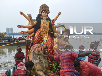 Devotees move an idol of the Hindu goddess Durga for immersion into the Ganges River, marking the last day of Durga Puja festival celebratio...