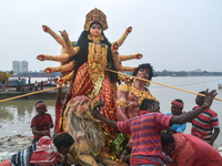 Devotees move an idol of the Hindu goddess Durga for immersion into the Ganges River, marking the last day of Durga Puja festival celebratio...