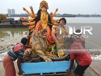 Devotees move an idol of the Hindu goddess Durga for immersion into the Ganges River, marking the last day of Durga Puja festival celebratio...