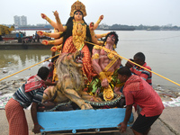 Devotees move an idol of the Hindu goddess Durga for immersion into the Ganges River, marking the last day of Durga Puja festival celebratio...