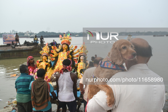 Devotees carry an idol of the Hindu goddess Durga for its immersion into the Ganges River on the last day of the Durga Puja festival in Kolk...