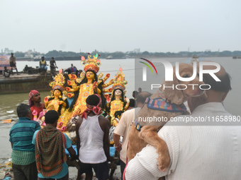 Devotees carry an idol of the Hindu goddess Durga for its immersion into the Ganges River on the last day of the Durga Puja festival in Kolk...