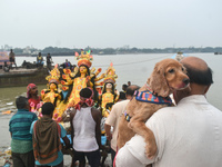 Devotees carry an idol of the Hindu goddess Durga for its immersion into the Ganges River on the last day of the Durga Puja festival in Kolk...