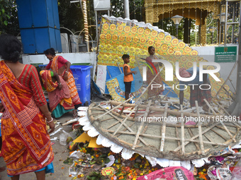 KMC workers clean the banks of the Ganges River on the last day of the Durga Puja festival in Kolkata, India, on October 12, 2024. (