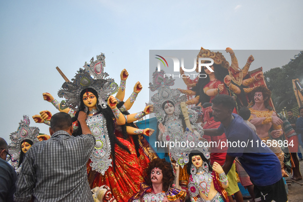 Devotees move an idol of the Hindu goddess Durga for immersion into the Ganges River, marking the last day of Durga Puja festival celebratio...