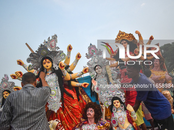 Devotees move an idol of the Hindu goddess Durga for immersion into the Ganges River, marking the last day of Durga Puja festival celebratio...