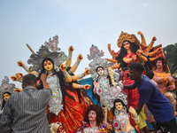 Devotees move an idol of the Hindu goddess Durga for immersion into the Ganges River, marking the last day of Durga Puja festival celebratio...