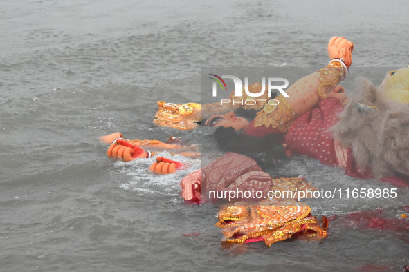 An idol of the Hindu goddess Durga floats after its immersion into the Ganges River, marking the last day of Durga Puja festival celebration...