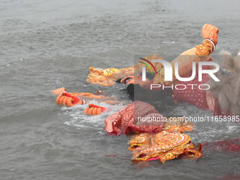 An idol of the Hindu goddess Durga floats after its immersion into the Ganges River, marking the last day of Durga Puja festival celebration...