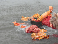 An idol of the Hindu goddess Durga floats after its immersion into the Ganges River, marking the last day of Durga Puja festival celebration...