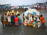 Devotees immerse idols of the Hindu goddess Durga into the Ganges River on the last day of the Durga Puja festival in Kolkata, India, on Oct...