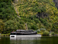 An electric tourist ferry ‘The Fjords’ navigates in the Nærøyfjord, in Gudvangen, Norway, on September 17, 2024. The village of Gudvangen is...