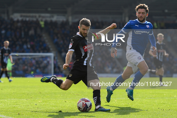 Dan Crowley of Notts County lines up a cross under pressure from Darren Oldaker of Chesterfield during the Sky Bet League 2 match between Ch...