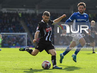 Dan Crowley of Notts County lines up a cross under pressure from Darren Oldaker of Chesterfield during the Sky Bet League 2 match between Ch...