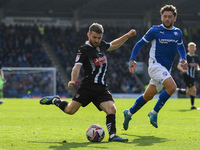 Dan Crowley of Notts County lines up a cross under pressure from Darren Oldaker of Chesterfield during the Sky Bet League 2 match between Ch...