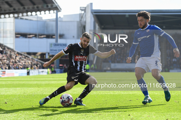 Dan Crowley of Notts County lines up a cross under pressure from Darren Oldaker of Chesterfield during the Sky Bet League 2 match between Ch...