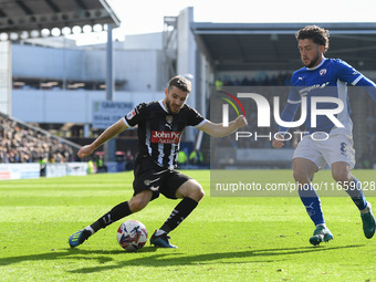 Dan Crowley of Notts County lines up a cross under pressure from Darren Oldaker of Chesterfield during the Sky Bet League 2 match between Ch...