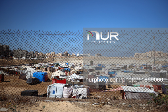 Displaced Palestinians shelter in a tent camp amid the Israel-Hamas conflict in Khan Younis, in the southern Gaza Strip, on October 12, 2024...