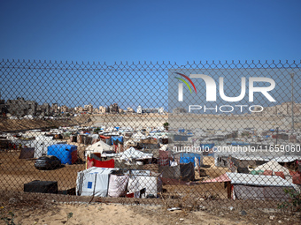 Displaced Palestinians shelter in a tent camp amid the Israel-Hamas conflict in Khan Younis, in the southern Gaza Strip, on October 12, 2024...