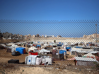 Displaced Palestinians shelter in a tent camp amid the Israel-Hamas conflict in Khan Younis, in the southern Gaza Strip, on October 12, 2024...