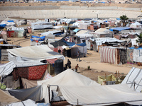 Displaced Palestinians shelter in a tent camp amid the Israel-Hamas conflict in Khan Younis, in the southern Gaza Strip, on October 12, 2024...