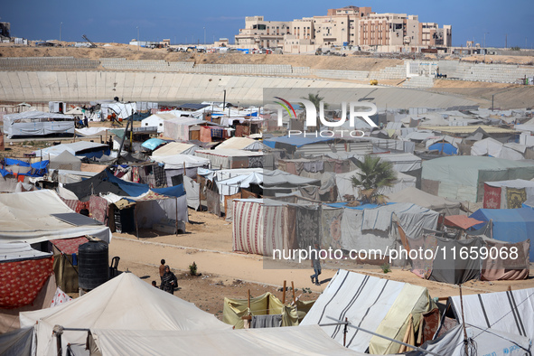 Displaced Palestinians shelter in a tent camp amid the Israel-Hamas conflict in Khan Younis, in the southern Gaza Strip, on October 12, 2024...