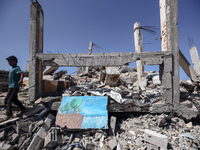 A boy walks near rubble and destroyed buildings amid the Israel-Hamas conflict in Khan Younis, in the southern Gaza Strip, on October 12, 20...