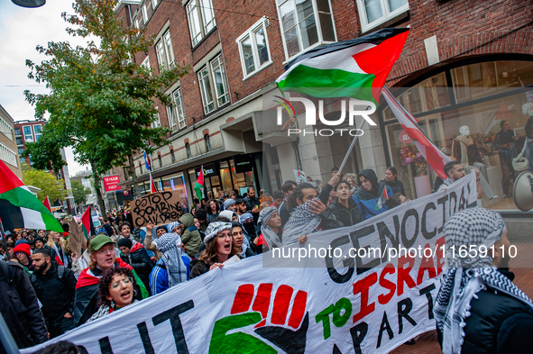 Around two hundred people march along the city center of Nijmegen, Netherlands, on October 12, 2024, to show their support for Palestine and...