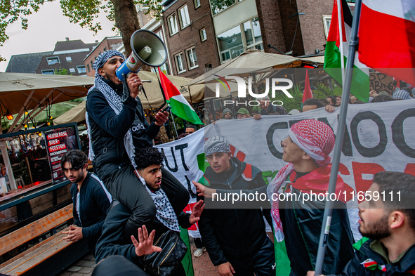 Around two hundred people march along the city center of Nijmegen, Netherlands, on October 12, 2024, to show their support for Palestine and...