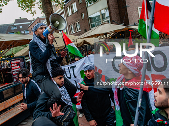 Around two hundred people march along the city center of Nijmegen, Netherlands, on October 12, 2024, to show their support for Palestine and...