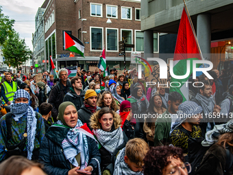 Around two hundred people march along the city center of Nijmegen, Netherlands, on October 12, 2024, to show their support for Palestine and...