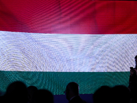 A Hungarian flag is displayed with people during the meeting of the presidents of the Arraiolos group at Wawel Castle in Krakow, Poland, on...