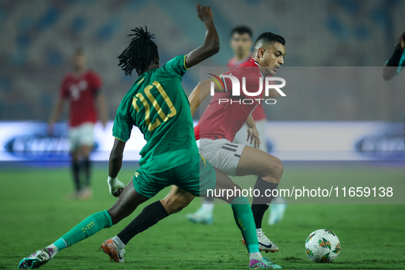 Mostafa Mohamed of Egypt battles for possession with Keita Ibrahima of Mauritania during the Africa Cup of Nations Qualifiers 2025, match nu...