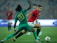 Mostafa Mohamed of Egypt battles for possession with Keita Ibrahima of Mauritania during the Africa Cup of Nations Qualifiers 2025, match nu...