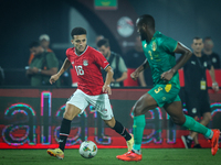 Mostafa Mohamed of Egypt battles for possession with Abeid Aly of Mauritania during Africa Cup of Nations qualifiers 2025, match number 61,...