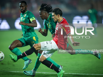 Mohamed Hamdy of Egypt battles for possession with Keita Ibrahima of Mauritania during the Africa Cup of Nations Qualifiers 2025, match numb...