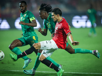 Mohamed Hamdy of Egypt battles for possession with Keita Ibrahima of Mauritania during the Africa Cup of Nations Qualifiers 2025, match numb...