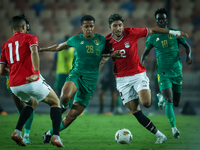 Omar Marmoush of Egypt battles for possession with Oumar Jacky Ngom of Mauritania during the Africa Cup of Nations Qualifiers 2025, match nu...