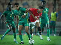 Omar Marmoush of Egypt battles for possession with Oumar Jacky Ngom of Mauritania during the Africa Cup of Nations Qualifiers 2025, match nu...