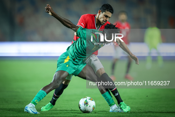 Mohamed Hamdy of Egypt battles for possession with Idrissa Thiam of Mauritania during Africa Cup of Nations Qualifiers 2025 match number 61...