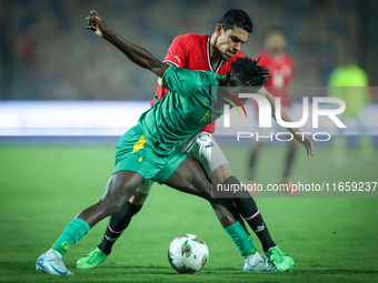 Mohamed Hamdy of Egypt battles for possession with Idrissa Thiam of Mauritania during Africa Cup of Nations Qualifiers 2025 match number 61...