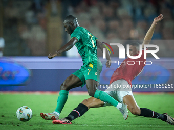 Ramy Rabiaa of Egypt battles for possession with Aboubakary Koita of Mauritania during the Africa Cup of Nations qualifiers 2025 match numbe...