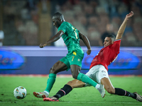 Ramy Rabiaa of Egypt battles for possession with Aboubakary Koita of Mauritania during the Africa Cup of Nations qualifiers 2025 match numbe...