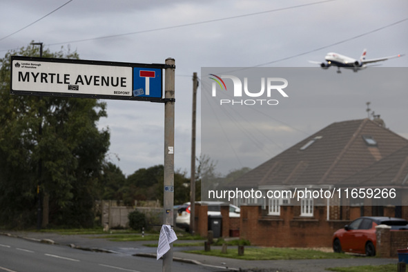 Sign with inscription of Myrtle Avenue with an aircraft in the background. British Airways Boeing 787-8 Dreamliner aircraft spotted flying o...