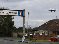 Sign with inscription of Myrtle Avenue with an aircraft in the background. British Airways Boeing 787-8 Dreamliner aircraft spotted flying o...