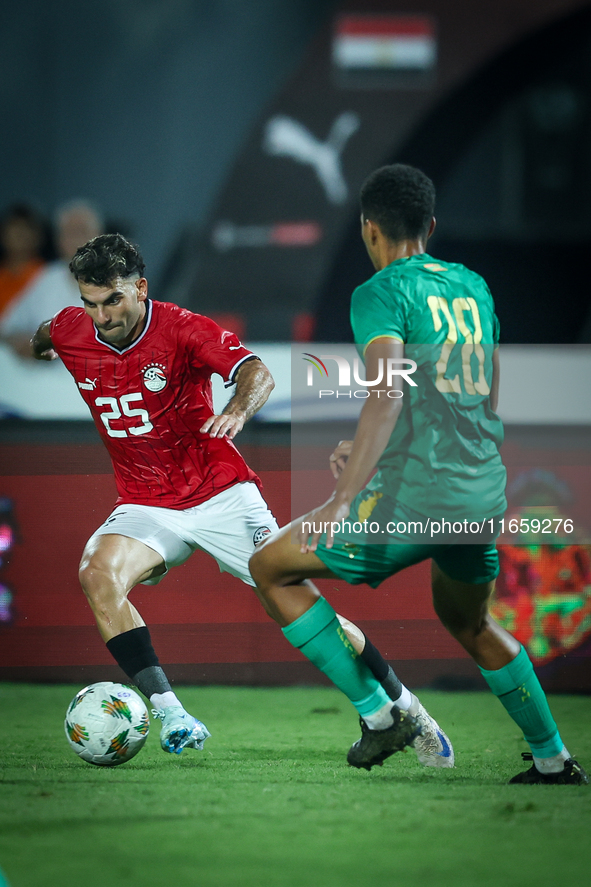 Ahmed Mostafa of Egypt battles for possession with Oumar Jacky Ngom of Mauritania during Africa Cup of Nations qualifiers 2025 match number...