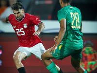 Ahmed Mostafa of Egypt battles for possession with Oumar Jacky Ngom of Mauritania during Africa Cup of Nations qualifiers 2025 match number...