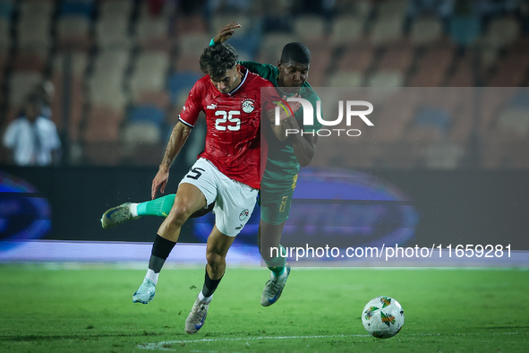 Ahmed Mostafa of Egypt battles for possession with Mouhsine Bodda of Mauritania during Africa Cup of Nations Qualifiers 2025 match number 61...