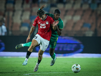 Ahmed Mostafa of Egypt battles for possession with Mouhsine Bodda of Mauritania during Africa Cup of Nations Qualifiers 2025 match number 61...